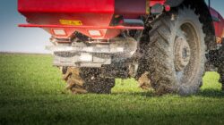 Tractor spreading fertiliser. | Newsreel