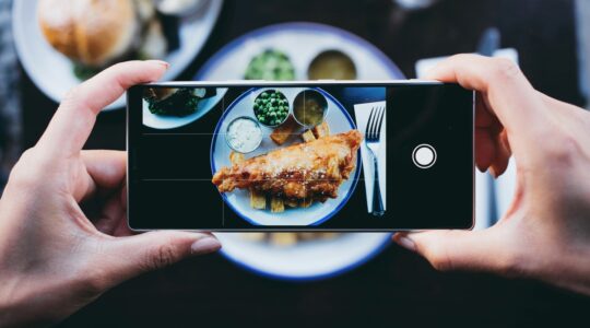 Person taking photo of food. | Newsreel