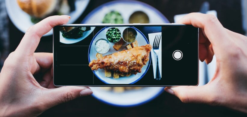 Person taking photo of food. | Newsreel