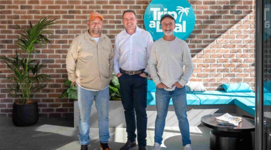 TripADeal founders Norm Black, left, and Richard Johnston, right, with Qantas Loyalty CEO Andrew Glance. | Newsreel