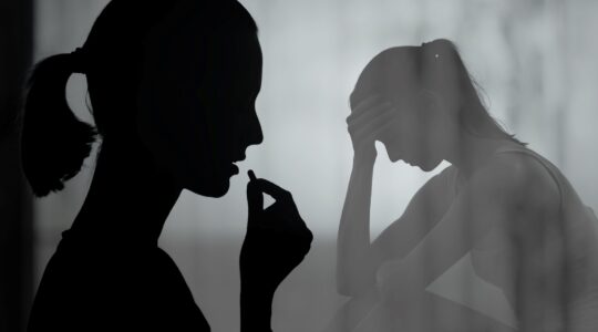 Women taking pill in shadows. | Newsreel