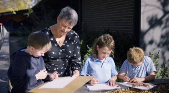 Teacher with students. | Newsreel