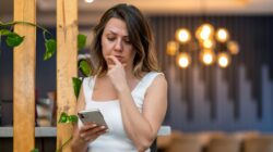 Worried woman looking at phone. | Newsreel