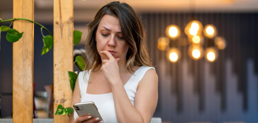 Worried woman looking at phone. | Newsreel