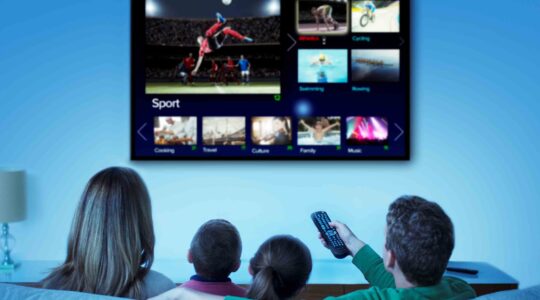 Family watching sport on TV. | Newsreel