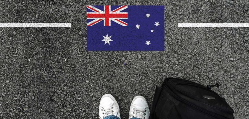 Feet of person about to cross line with Australian flag. | Newsreel
