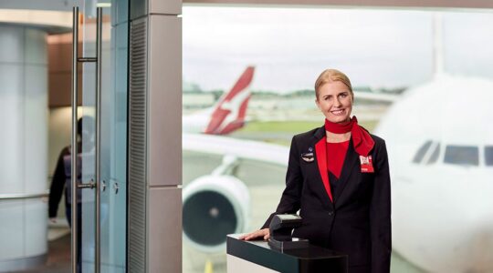 Qantas crew member at boarding gate. | Newsreel