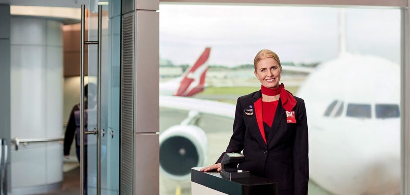 Qantas crew member at boarding gate. | Newsreel