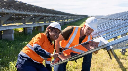 Electrician and apprentice installing solar panels. | Newsreel