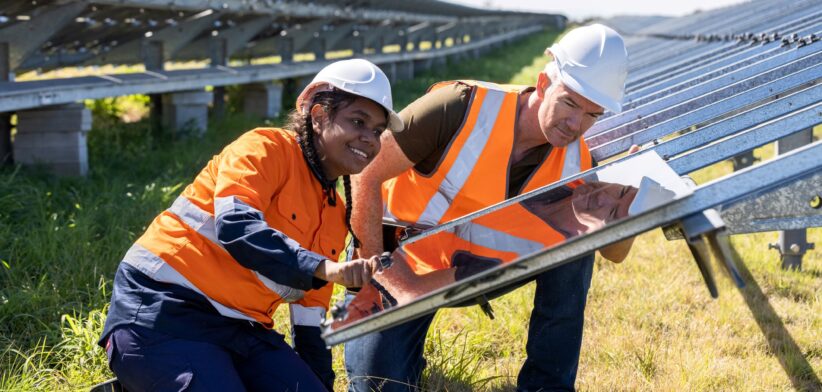 Electrician and apprentice installing solar panels. | Newsreel