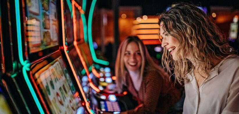 Two women at poker machines. | Newsreel