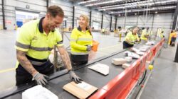 Australia Post staff at Gold Coast parcel sorting facility. | Newsreel