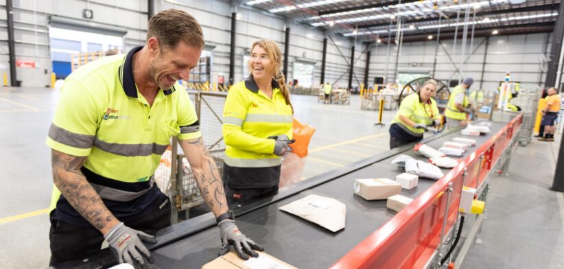 Australia Post staff at Gold Coast parcel sorting facility. | Newsreel