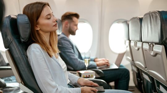 Woman sleeping on a plane. | Newsreel