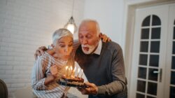 Older couple blowing out birthday candles. | Newsreel