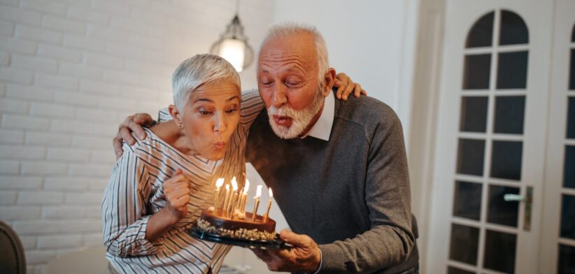 Older couple blowing out birthday candles. | Newsreel