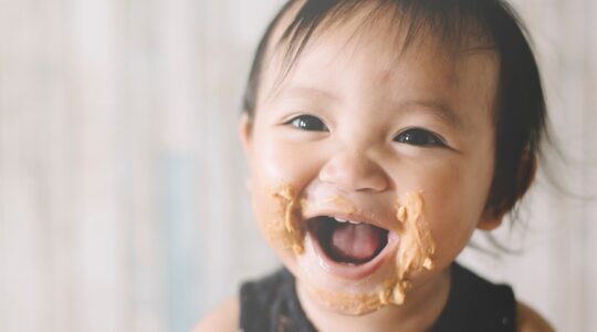 Baby with peanut butter on face. | Newsreel