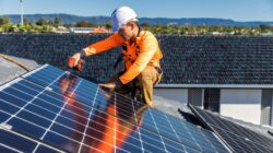 Worker installing roof-top solar. | Newsreel