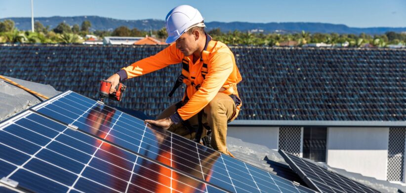 Worker installing roof-top solar. | Newsreel