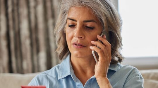 Woman with credit card on phone. | Newsreel