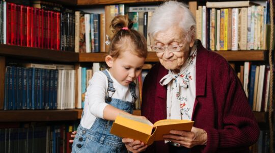 Young and old person reading a book. | Newsreel