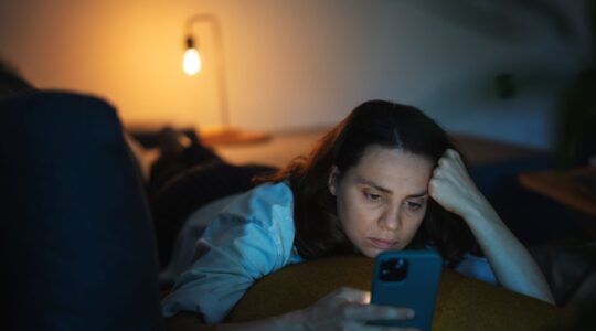 Worried woman scrolling through phone. | Newsreel