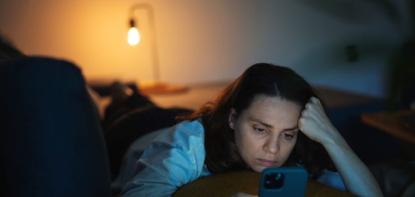 Worried woman scrolling through phone. | Newsreel