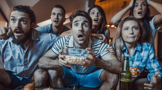 Sports fans watching TV. | Newsreel