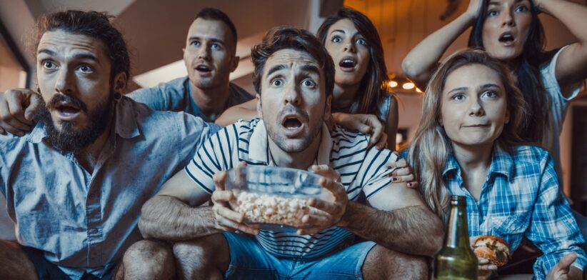 Sports fans watching TV. | Newsreel