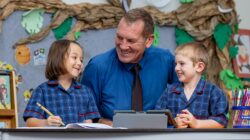 All Saints School principal Robert Campbell with students. | Newsreel