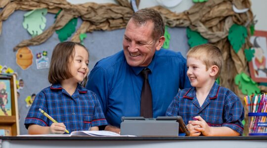 All Saints School principal Robert Campbell with students. | Newsreel