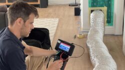 CSIRO researcher conducting a home air tightness test. | Newsreel