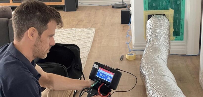 CSIRO researcher conducting a home air tightness test. | Newsreel