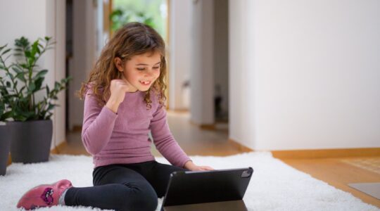 Child watching content on a computer. | Newsreel