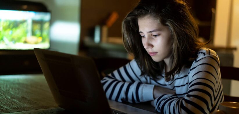 Worried child looking at computer. | Newsreel