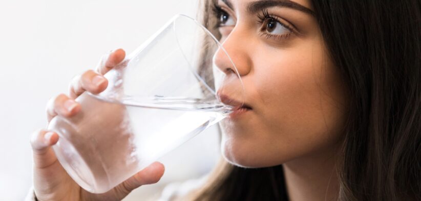 Woman drinking water out of glass. | Newsreel