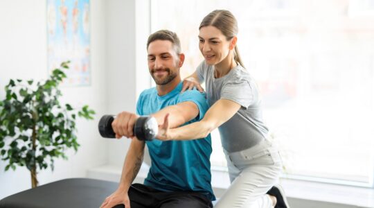 Woman treating man with exercise. | Newsreel