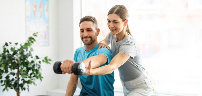 Woman treating man with exercise. | Newsreel