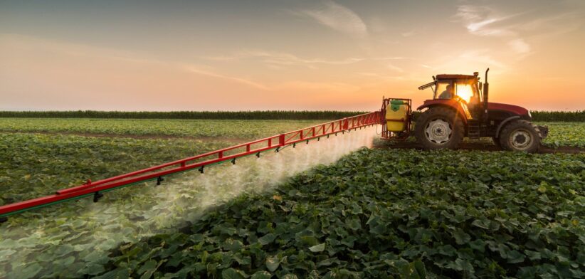 Farmer spraying on tractor. | Newsreel