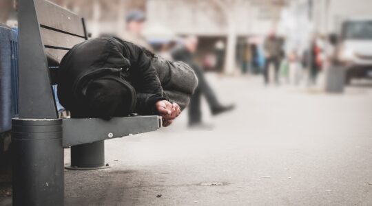 Homeless person on park bench. | Newsreel