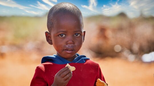 Young African child eating. | Newsreel