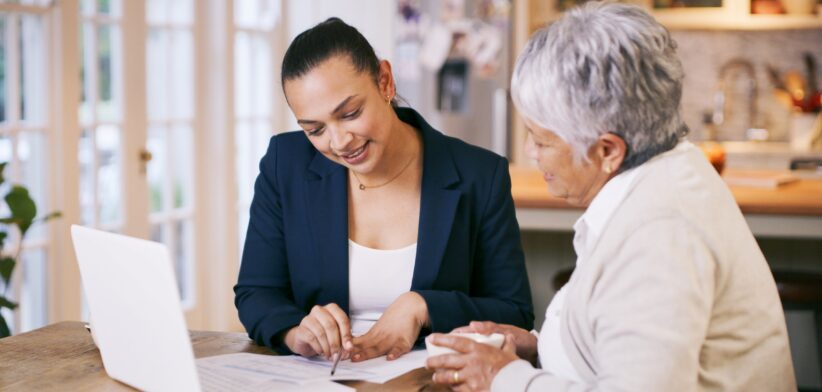 Two women looking over paperwork. | Newsreel