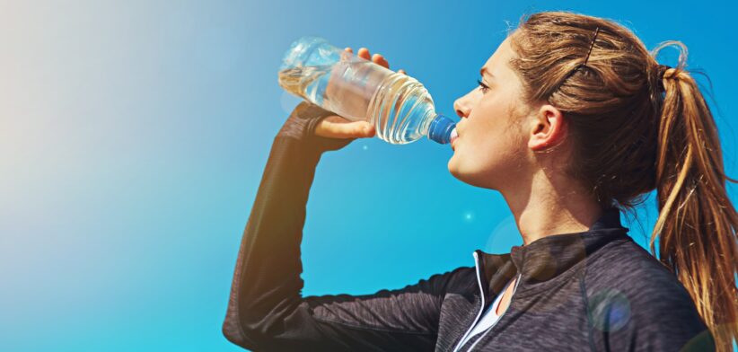 Woman drinking from plastic water bottle. | Newsreel