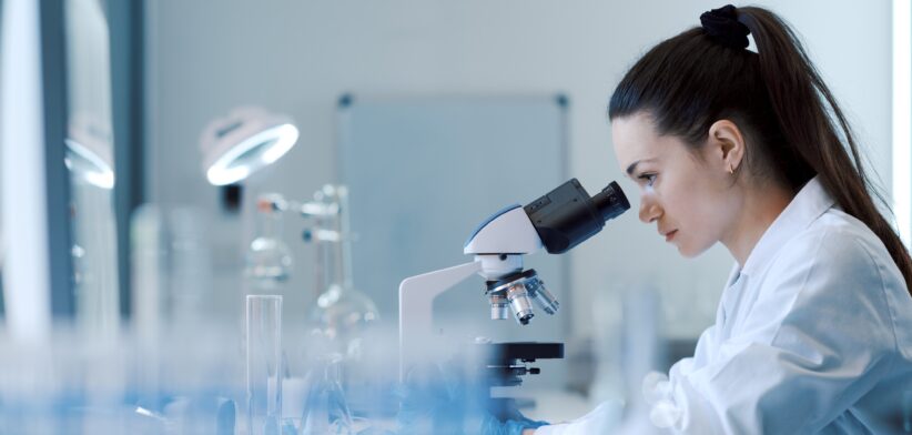 Female scientist in lab. | Newsreel