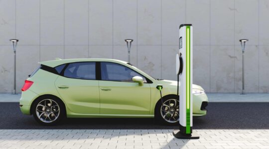 Electric vehicle at charging station. | Newsreel