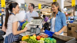 Woman at grocery market checkout. | Newsreel