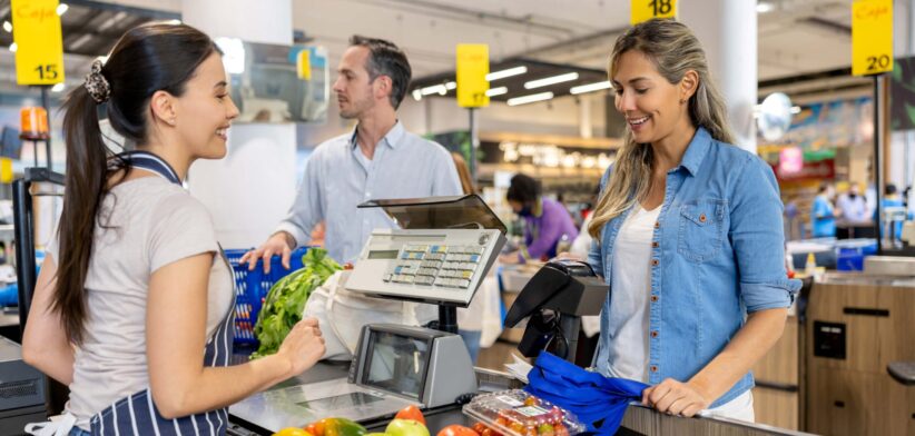 Woman at grocery market checkout. | Newsreel