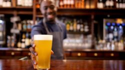 Bartender handing over a drink. | Newsreel