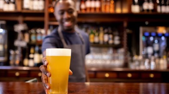 Bartender handing over a drink. | Newsreel