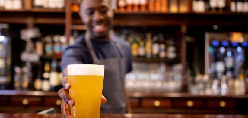 Bartender handing over a drink. | Newsreel